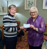 President Mairhi presents a &pound;300 cheque to Maria Walker
